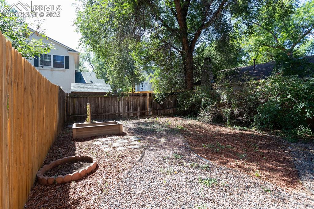 414 West Cheyenne Road Colorado Springs, CO 80906 - Photo 29 of 45 a view of a backyard with a trees and wooden fence