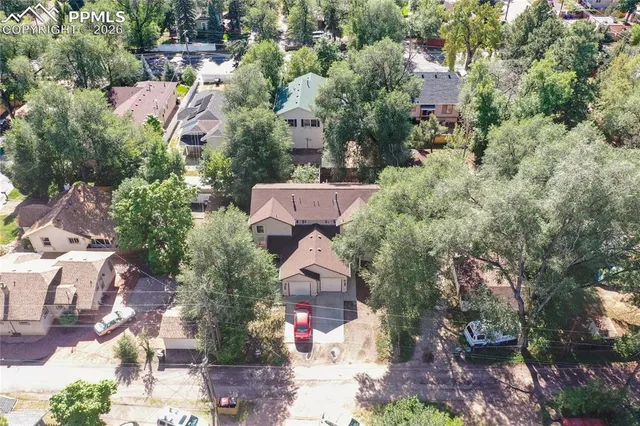 an aerial view of a house with a yard and lake view