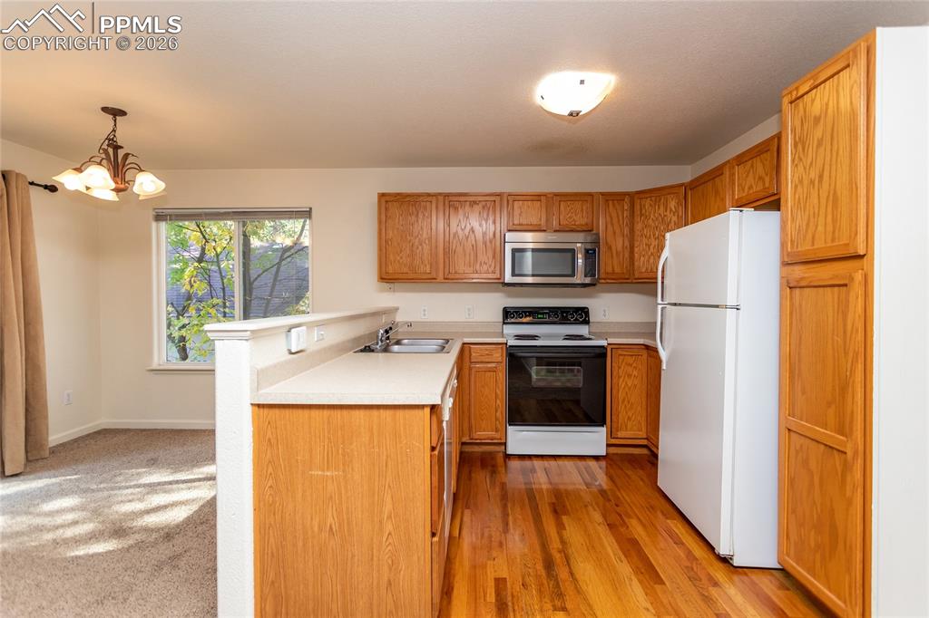 414 West Cheyenne Road Colorado Springs, CO 80906 - Photo 6 of 45 a kitchen with a refrigerator a stove top oven a sink and dishwasher