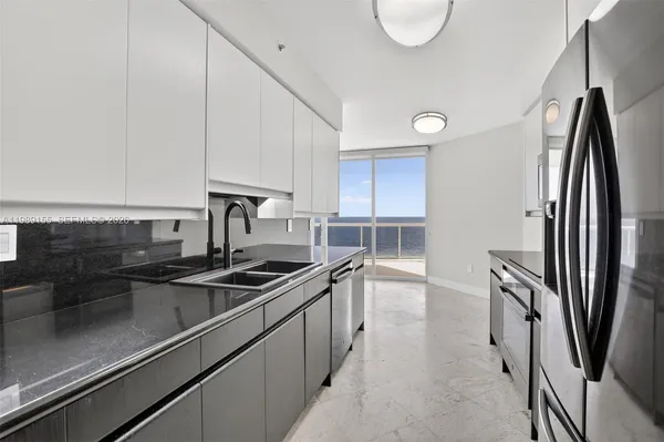a view of a patio with table and chairs and potted plants