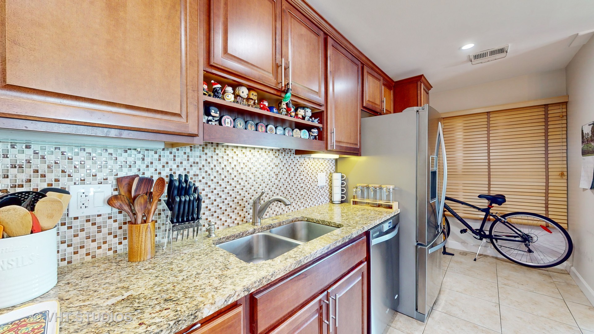 8630 Waukegan Road, Unit 519 Morton Grove, IL 60053 - Photo 12 of 26 a view of a kitchen with a sink and a refrigerator