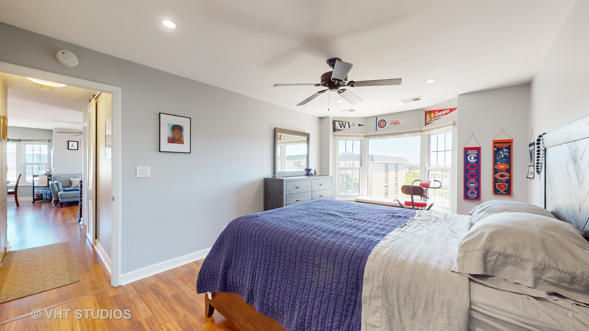 8630 Waukegan Road, Unit 519 Morton Grove, IL 60053 - Photo 18 of 26 a bedroom with a bed and a chandelier