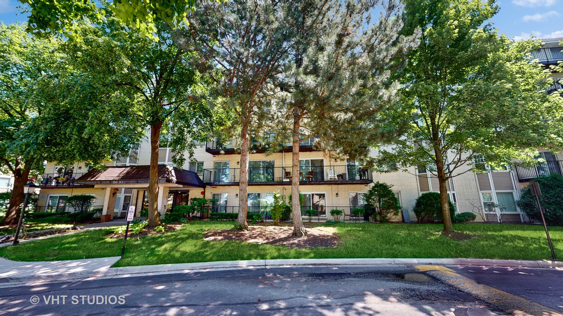 8630 Waukegan Road, Unit 519 Morton Grove, IL 60053 - Photo 2 of 26 a front view of a house with a garden