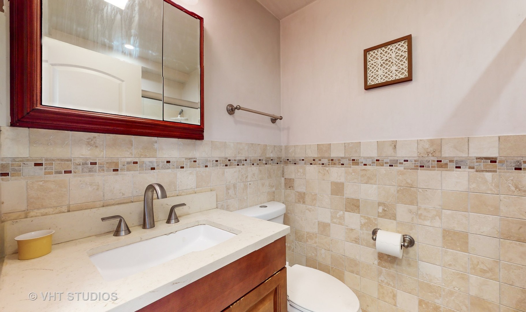 8630 Waukegan Road, Unit 519 Morton Grove, IL 60053 - Photo 22 of 26 a bathroom with a sink toilet and a mirror