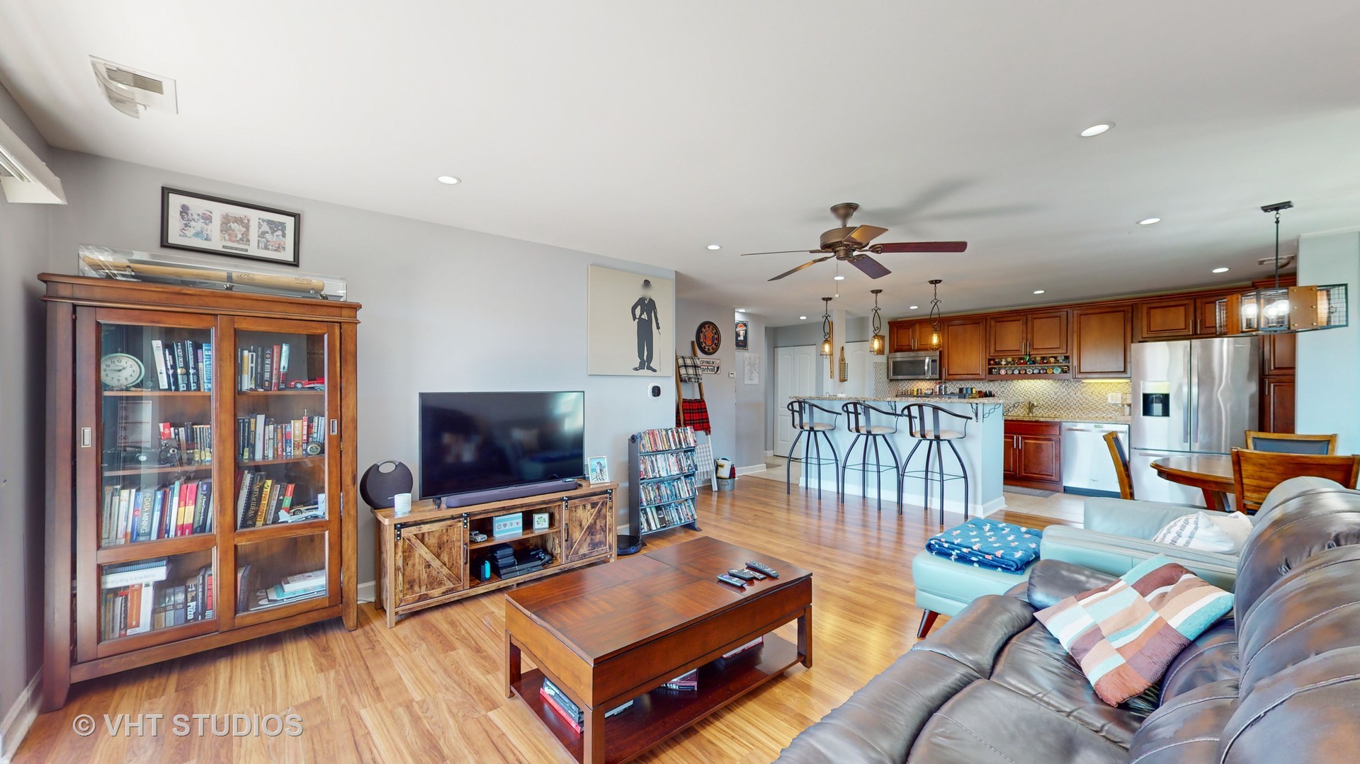 8630 Waukegan Road, Unit 519 Morton Grove, IL 60053 - Photo 4 of 26 a living room with furniture a flat screen tv and a floor to ceiling window