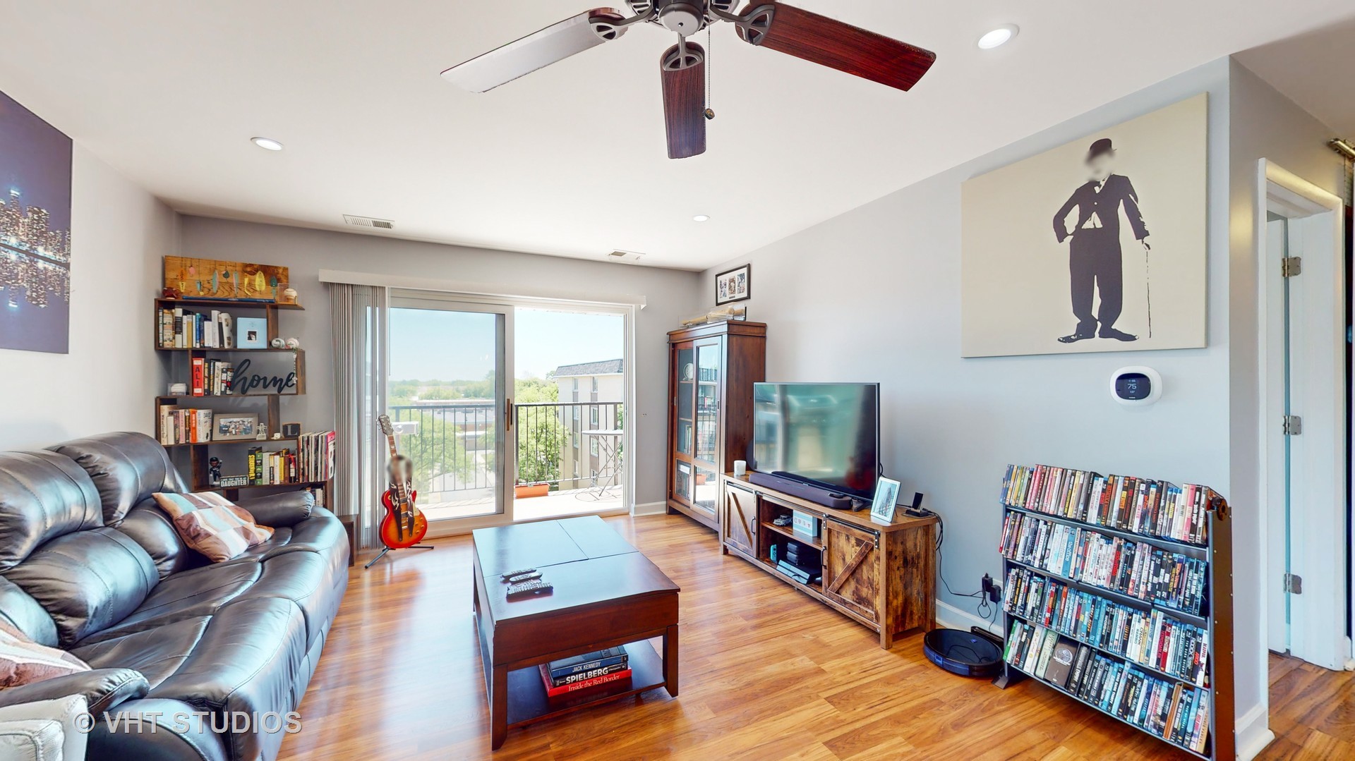 8630 Waukegan Road, Unit 519 Morton Grove, IL 60053 - Photo 6 of 26 a living room with furniture and a flat screen tv