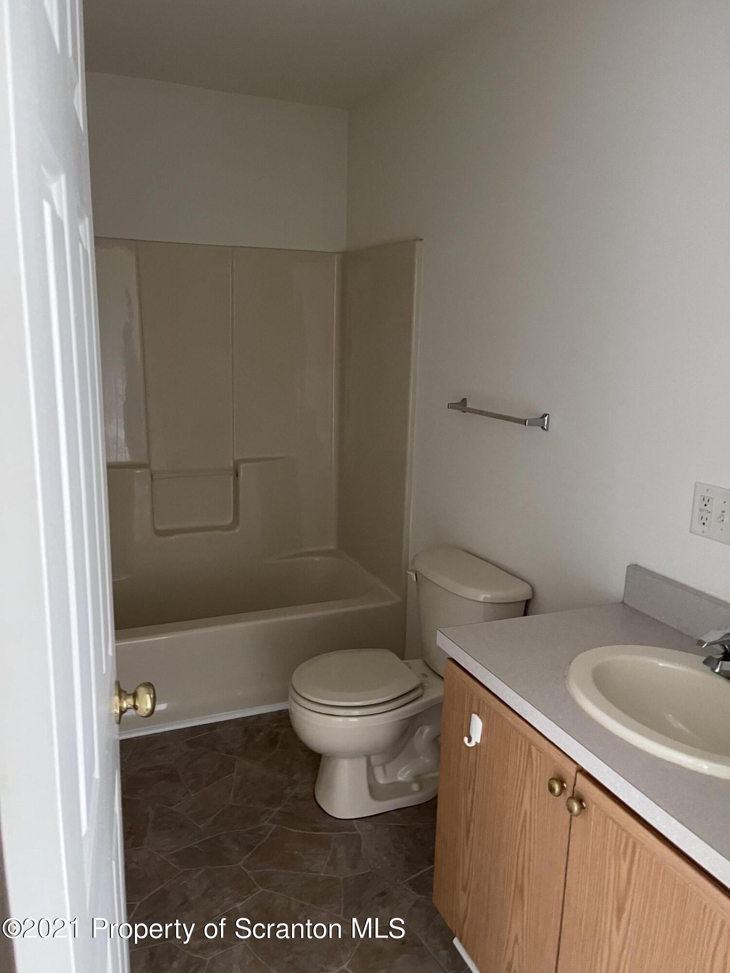 217 Elm Street Moosic, PA 18507 - Photo 13 of 15 a bathroom with a toilet a sink and bathtub