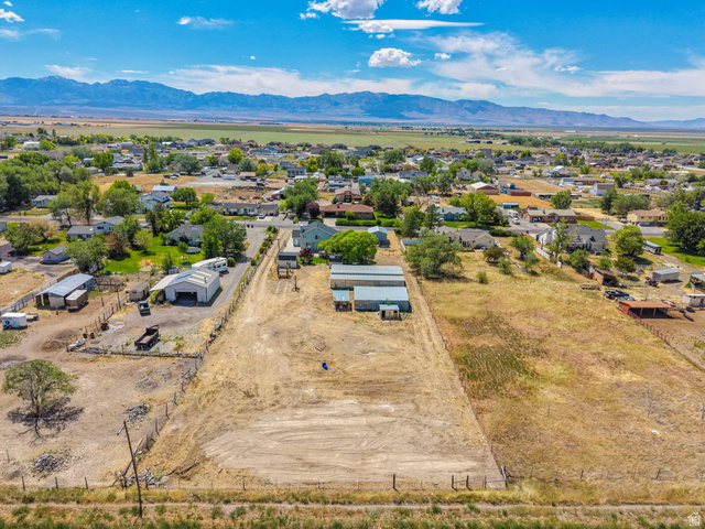 3732 Campbell Road Tooele, UT 84074 - Photo 63 of 69 Expansive land parcel featuring existing structures, a partially fenced perimeter, and a gravel driveway