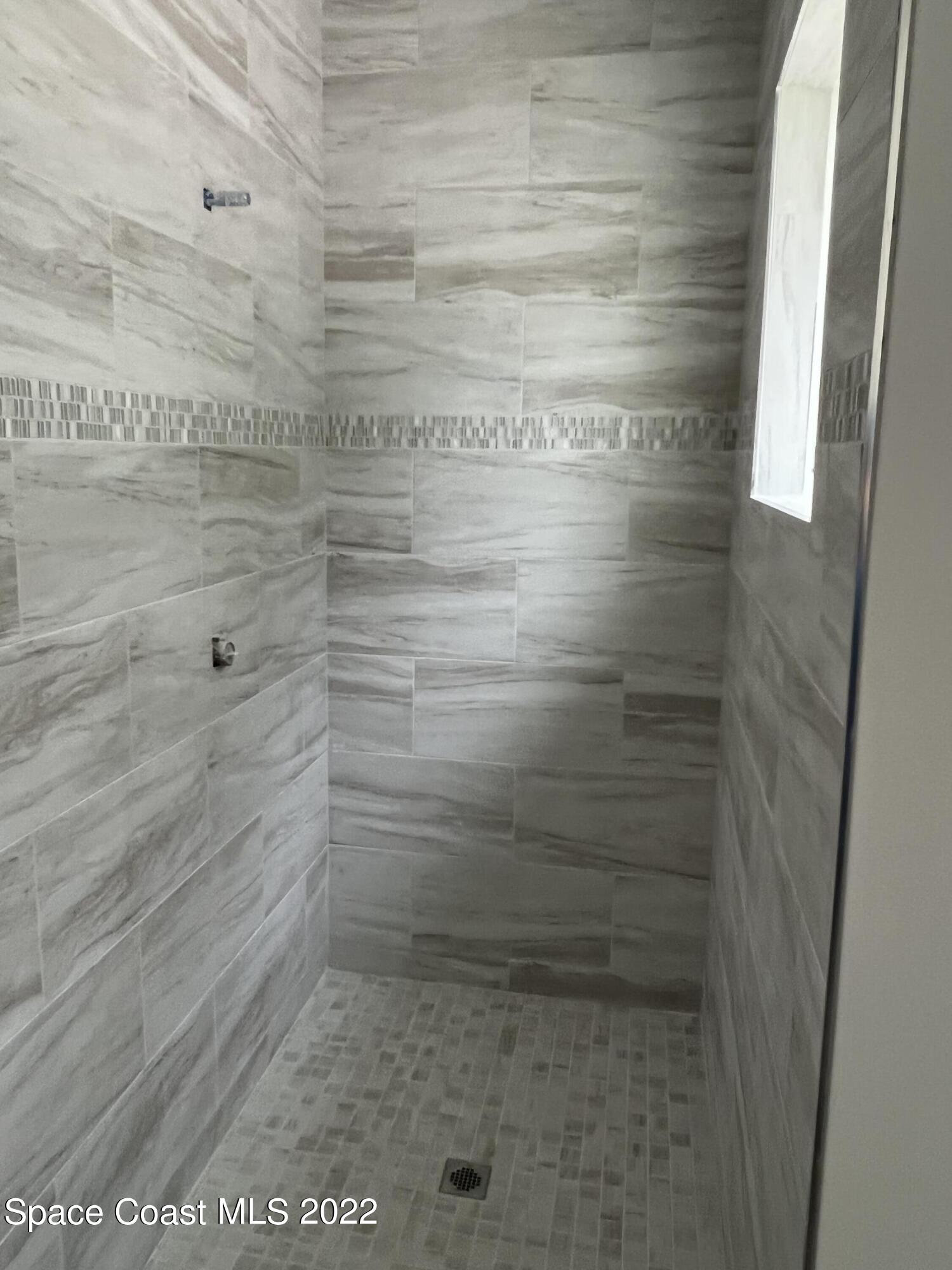 1376 Wing Road Southwest Palm Bay, FL 32908 - Photo 12 of 17 a bathroom with a shower