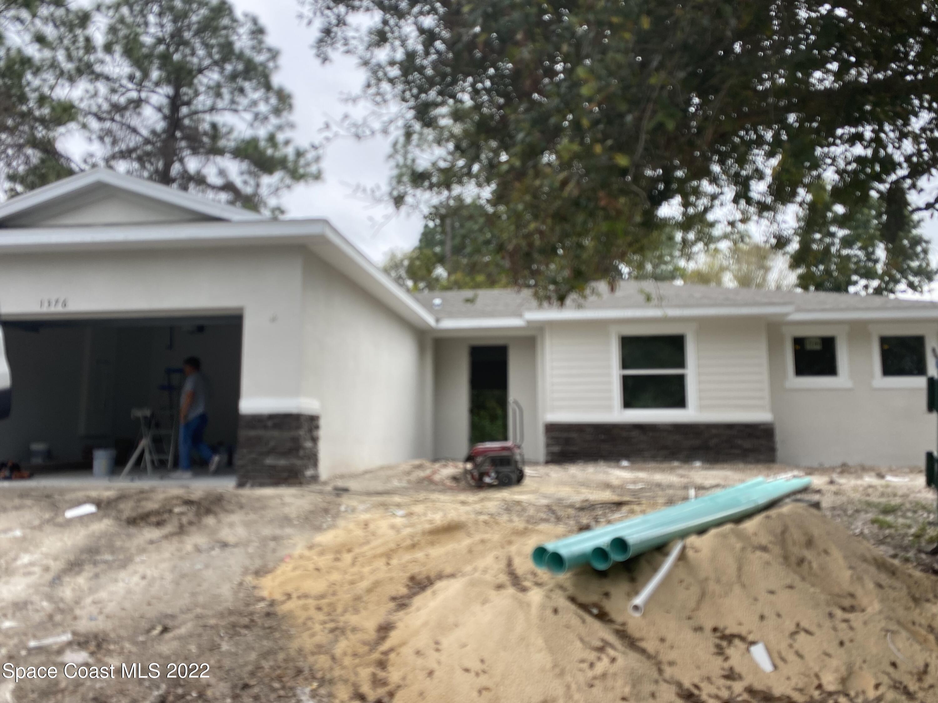 1376 Wing Road Southwest Palm Bay, FL 32908 - Photo 15 of 17 a view of a house with a yard covered with snow