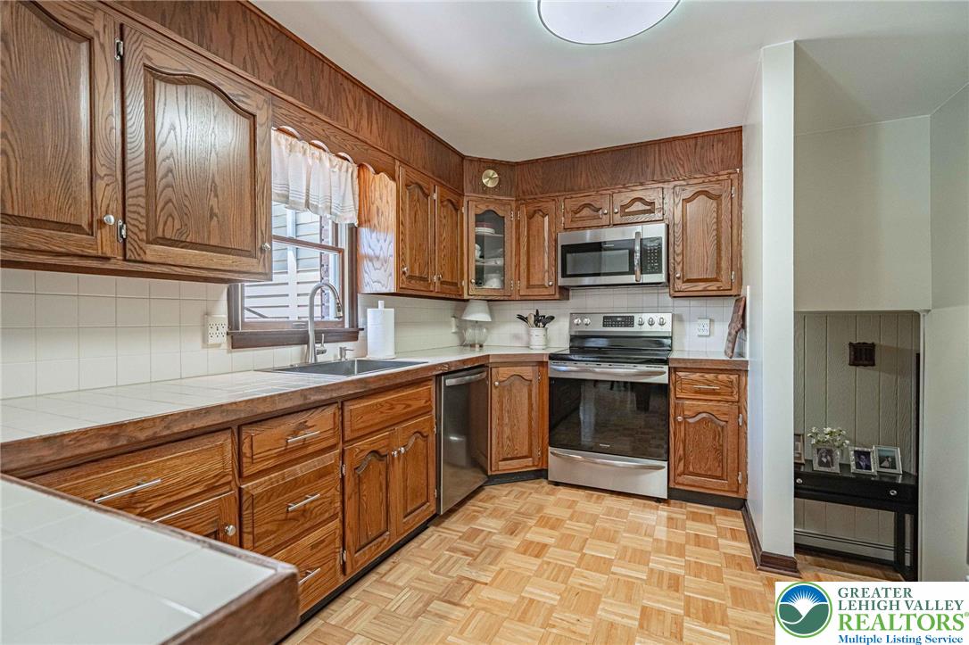 3857 Friedens Road Slatington, PA 18080 - Photo 27 of 75 This functional kitchen provides a warm, inviting space for culinary endeavors and casual dining.