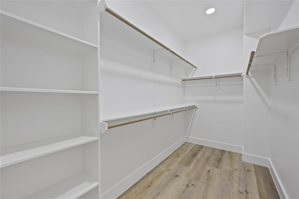 1805 Emir Street, Unit L Houston, TX 77009 - Photo 19 of 35 The oversized closet in the primary suite provides ample storage with built-in shelves and rods for hanging coats, dresses, and storing shoes and bags.