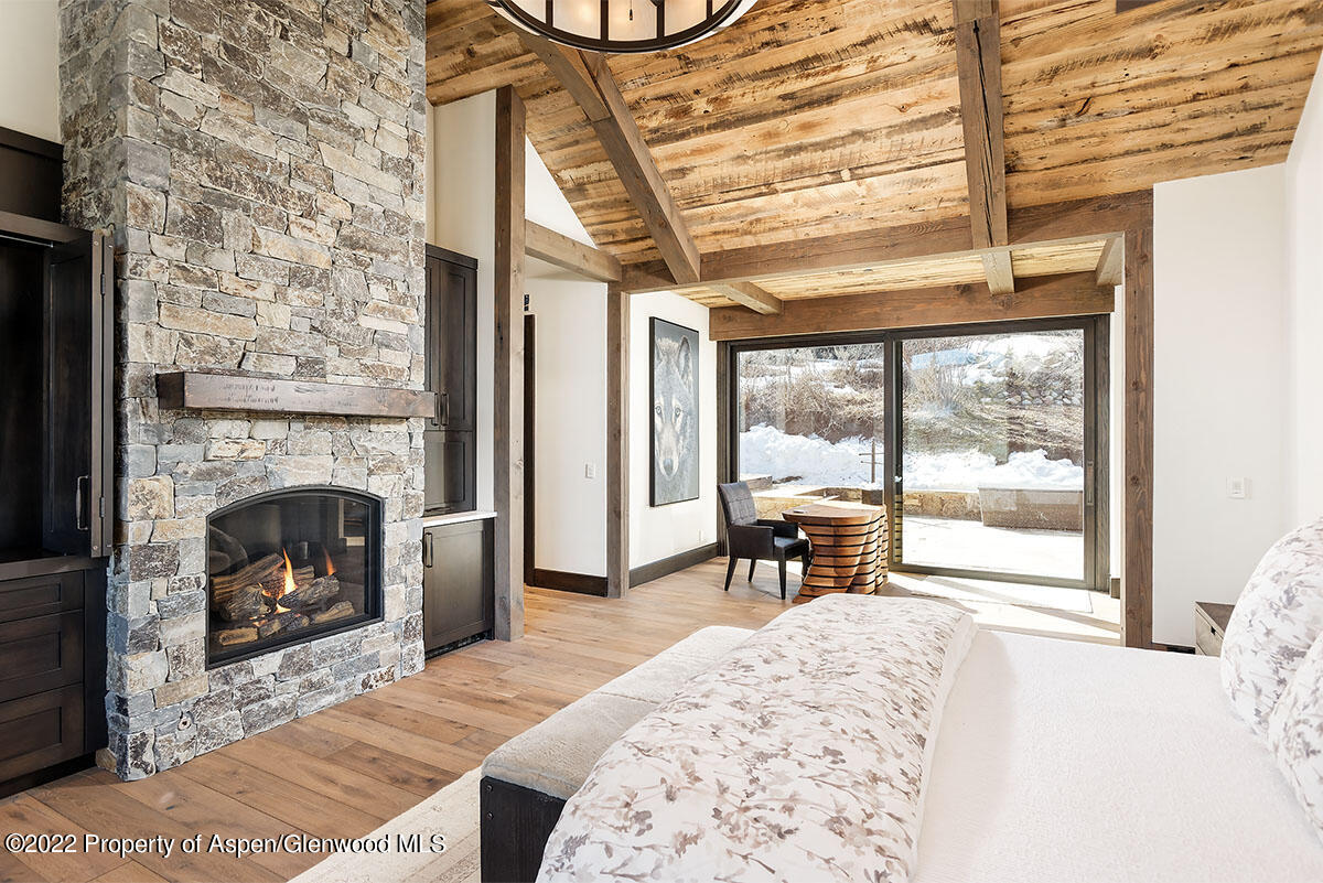 2322 Lazy O Road Snowmass, CO 81654 - Photo 12 of 42 a living room with a fireplace furniture and a large window