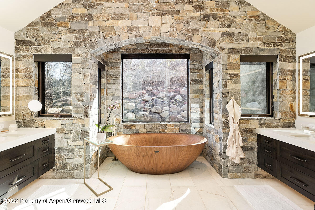 2322 Lazy O Road Snowmass, CO 81654 - Photo 13 of 42 a spacious bathroom with a tub a sink and a mirror