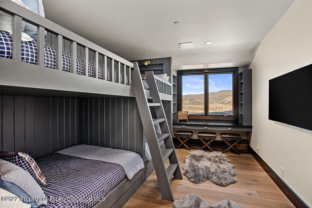 2322 Lazy O Road Snowmass, CO 81654 - Photo 19 of 42 a bedroom with a bed and a flat tv screen