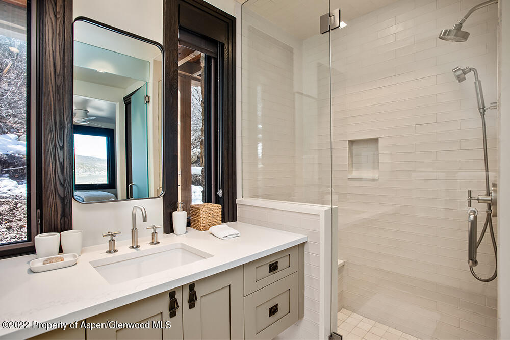 2322 Lazy O Road Snowmass, CO 81654 - Photo 25 of 42 a bathroom with a granite countertop sink mirror and a shower