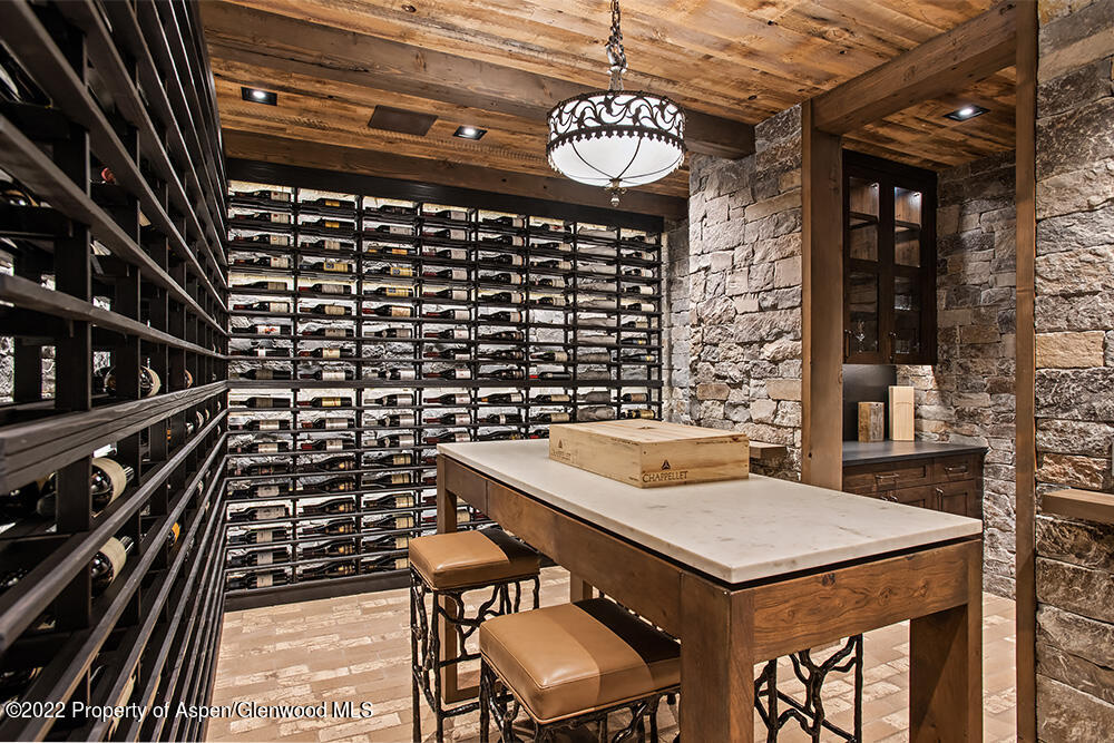 2322 Lazy O Road Snowmass, CO 81654 - Photo 26 of 42 a kitchen with a sink a stove and chairs