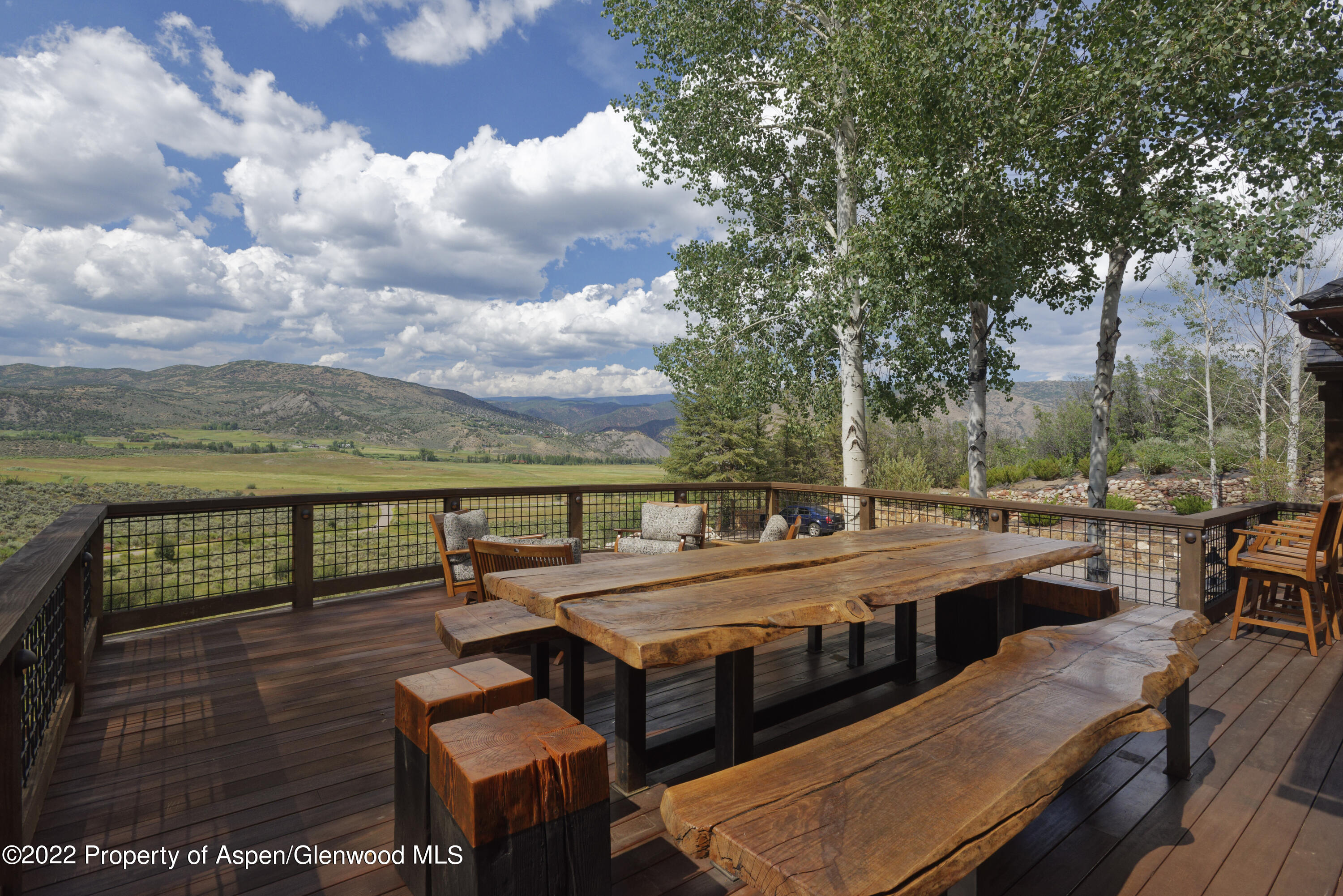 2322 Lazy O Road Snowmass, CO 81654 - Photo 31 of 42 a view of a patio with table and chairs and wooden floor