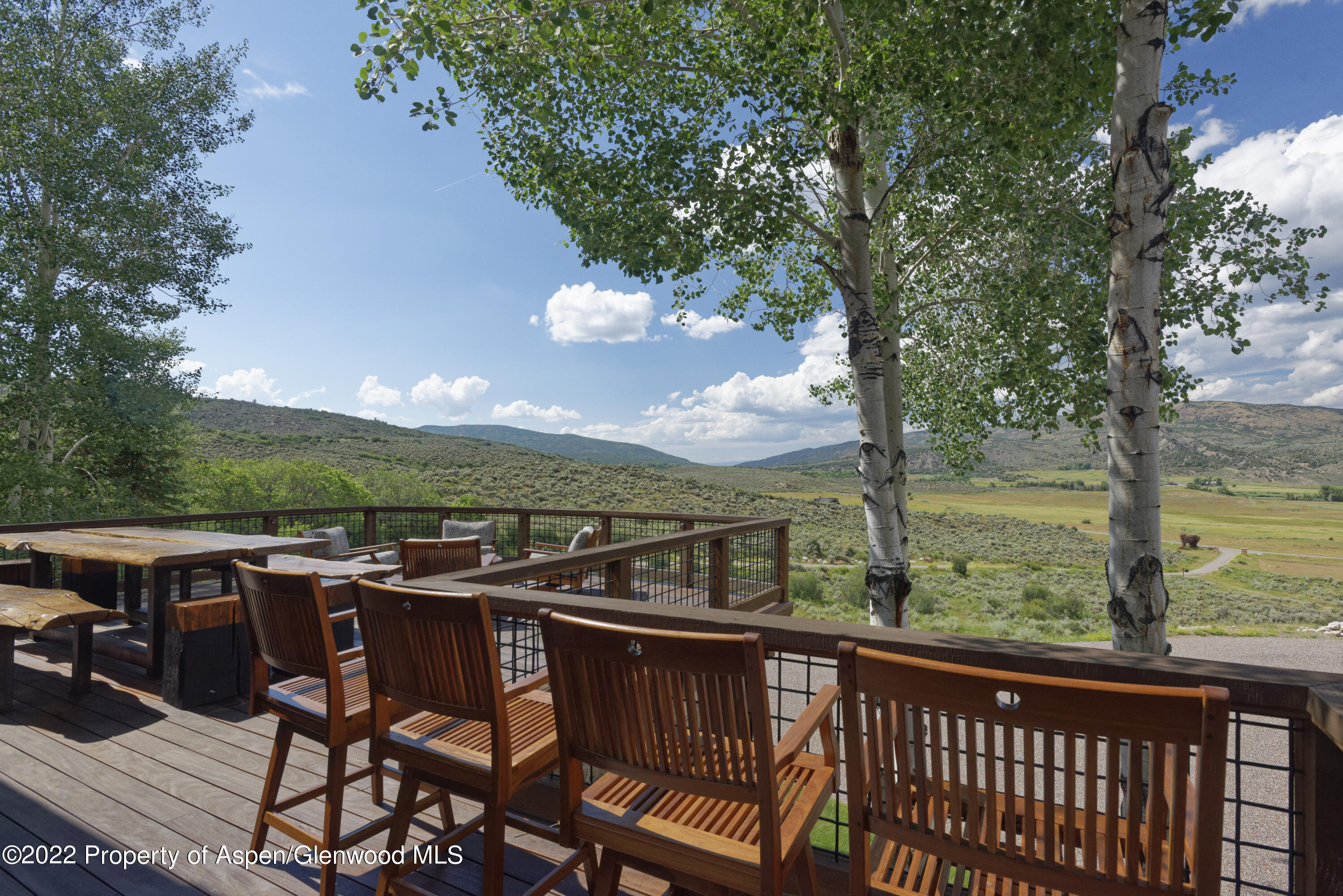2322 Lazy O Road Snowmass, CO 81654 - Photo 34 of 42 a view of a wooden chairs and table in the balcony