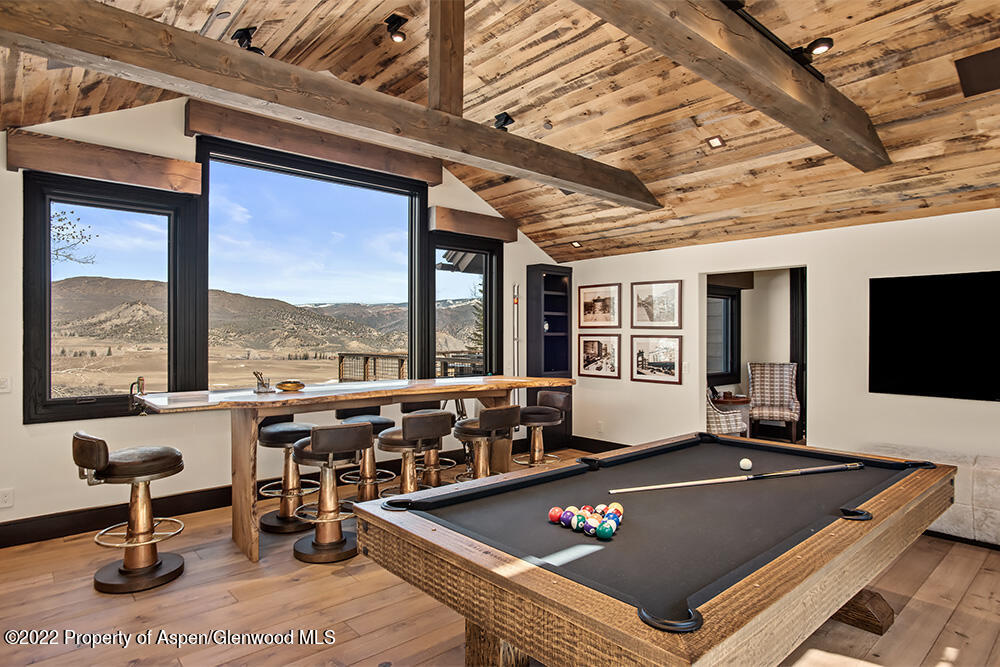 2322 Lazy O Road Snowmass, CO 81654 - Photo 9 of 42 a living room with furniture a flat screen tv and a large window