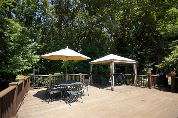 18 Peachtree Road Lexington, MA 02420 - Photo 18 of 22 a roof deck with table and chairs under an umbrella