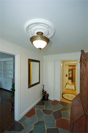 18 Peachtree Road Lexington, MA 02420 - Photo 2 of 22 a room that has a bed and a chandelier