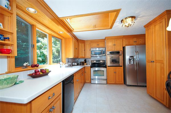 18 Peachtree Road Lexington, MA 02420 - Photo 3 of 22 a kitchen with stainless steel appliances a sink window and refrigerator