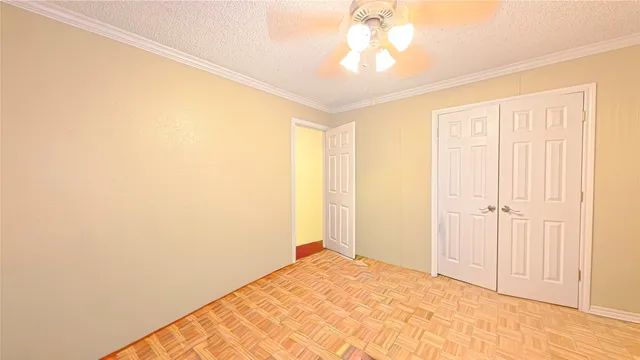 a view of a room with a chandelier fan and a window