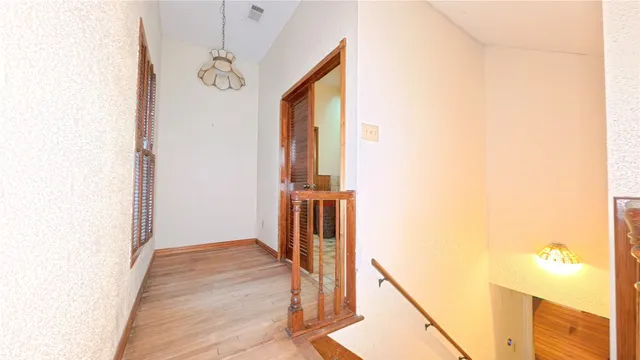 a view of a hallway with windows