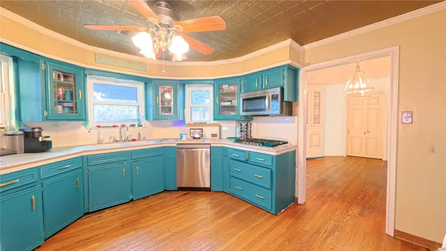 a kitchen with kitchen island a sink stainless steel appliances and cabinets