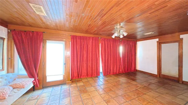 a view of a room with window and a bed