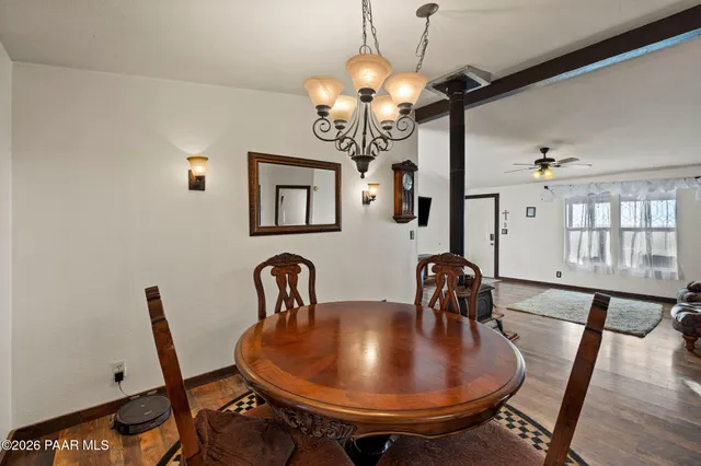 a view of a dining room with furniture and chandelier