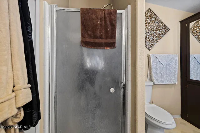 a bathroom with a toilet and a shower