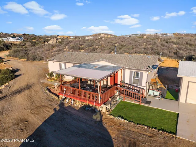 an aerial view of a house with a big yard