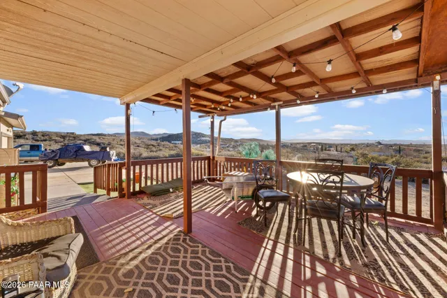 a view of a balcony with furniture and wooden floor