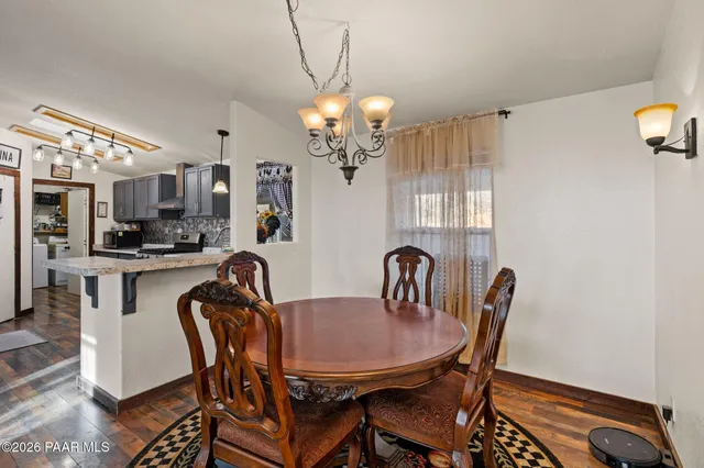a view of a dining room with furniture and a chandelier