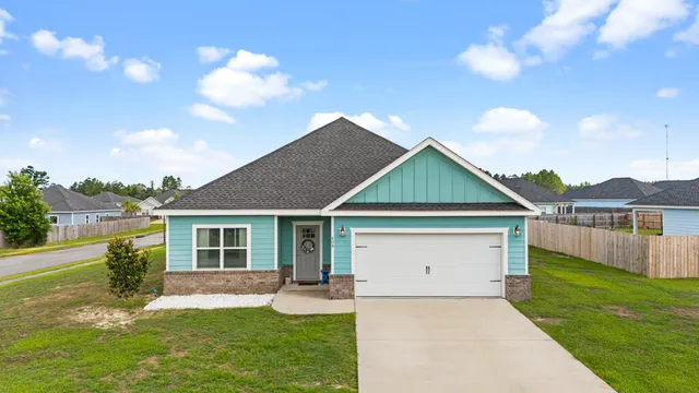 a front view of house with yard and green space
