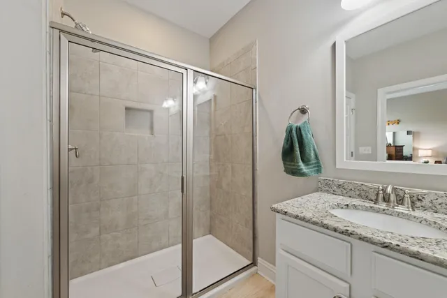 a bathroom with a granite countertop sink and a mirror