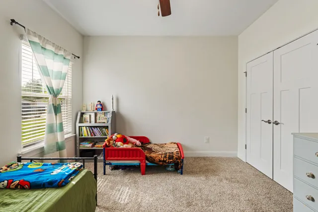 a bedroom with bed and a window