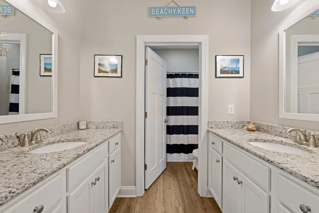 a spacious bathroom with a granite countertop sink and a mirror