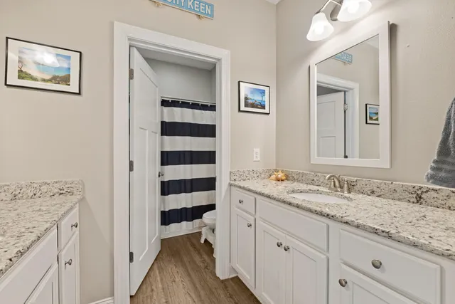 a spacious bathroom with a granite countertop sink mirror and