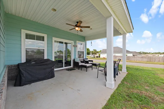 a view of a patio with couches chairs and potted plants