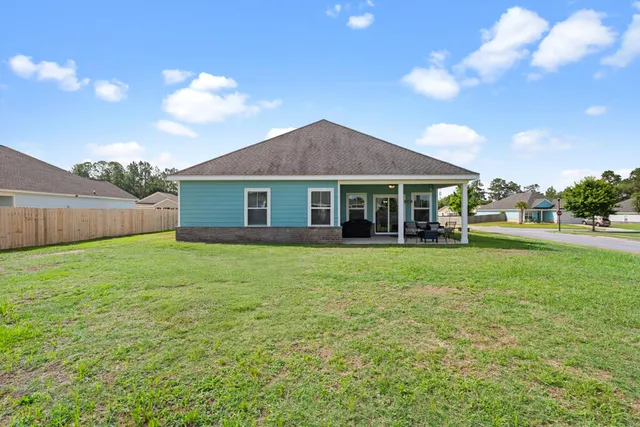 a view of a house with a backyard