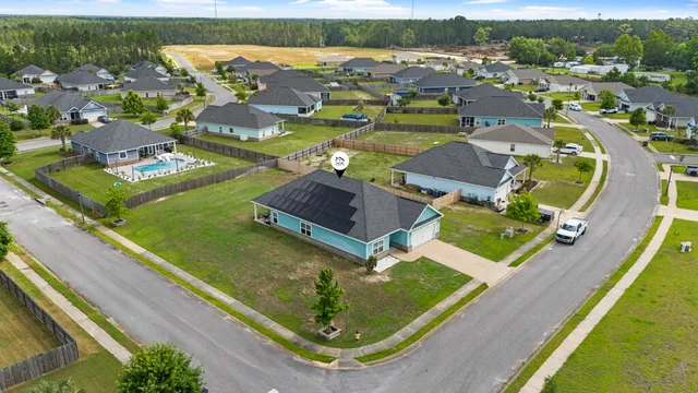an aerial view of residential houses with outdoor space
