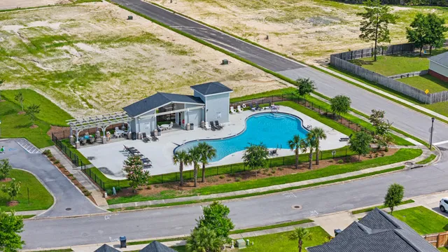 an aerial view of a house with a yard and potted plants