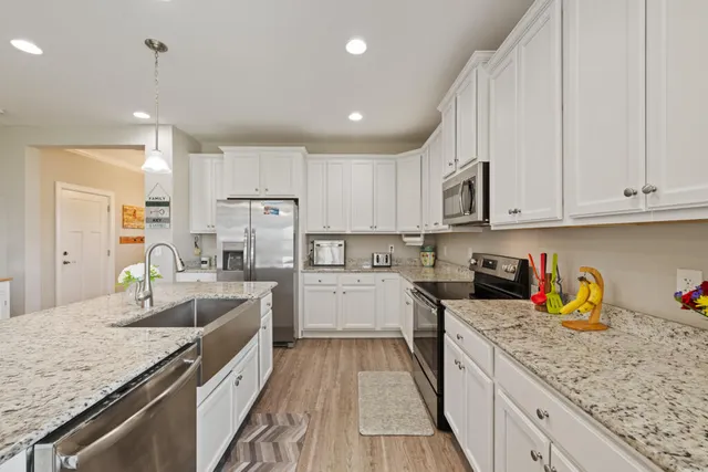 a kitchen with granite countertop lots of counter top space and stainless steel appliances