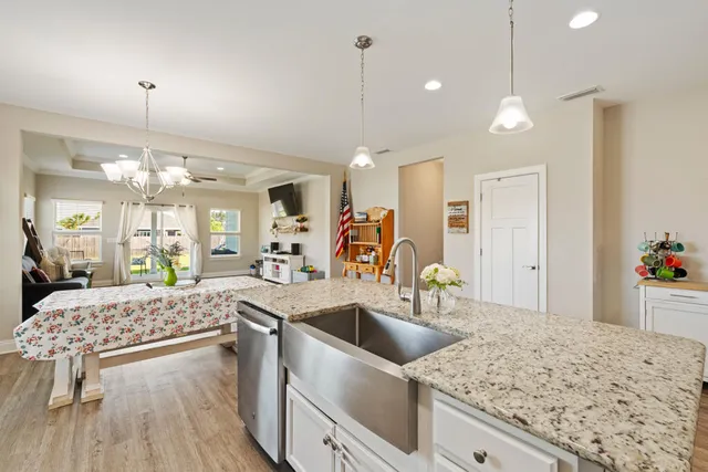 a kitchen with counter top space a sink stainless steel appliances and cabinets