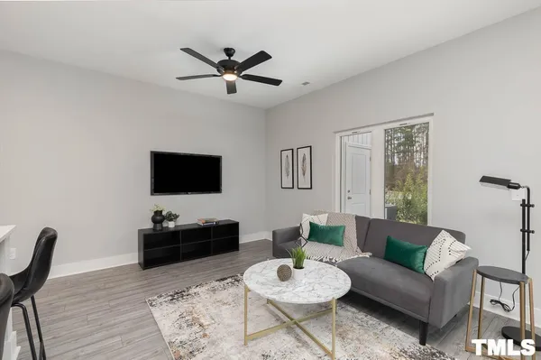a living room with furniture a rug and a flat screen tv