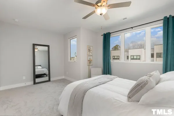 a bedroom with a large bed and a window