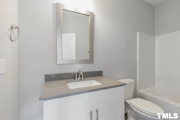 a bathroom with a sink toilet and a mirror